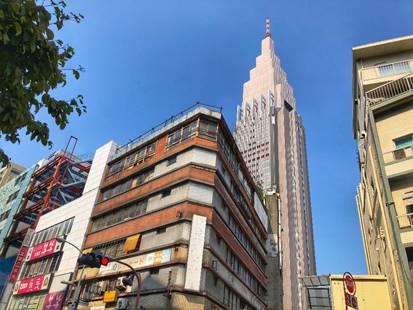 Das Yoyogi Kaikan Building
Das siebenstöckige Gebäude, in dem sich so viele wichtige Szenen des Films abspielen, existierte auch in der Realität. Bis zum August 2019 stand das Yoyogi Kaikan Building im Vergnügungsstadtteil Shibuya, wurde dann jedoch abgerissen. In WEATHERING WITH YOU spielt es eine tragende Rolle, immer wieder laufen Handlungsfäden hier zusammen, auch der Schrein steht auf dem Dach des Gebäudes. Koordinaten: http://bit.ly/30AqxIh