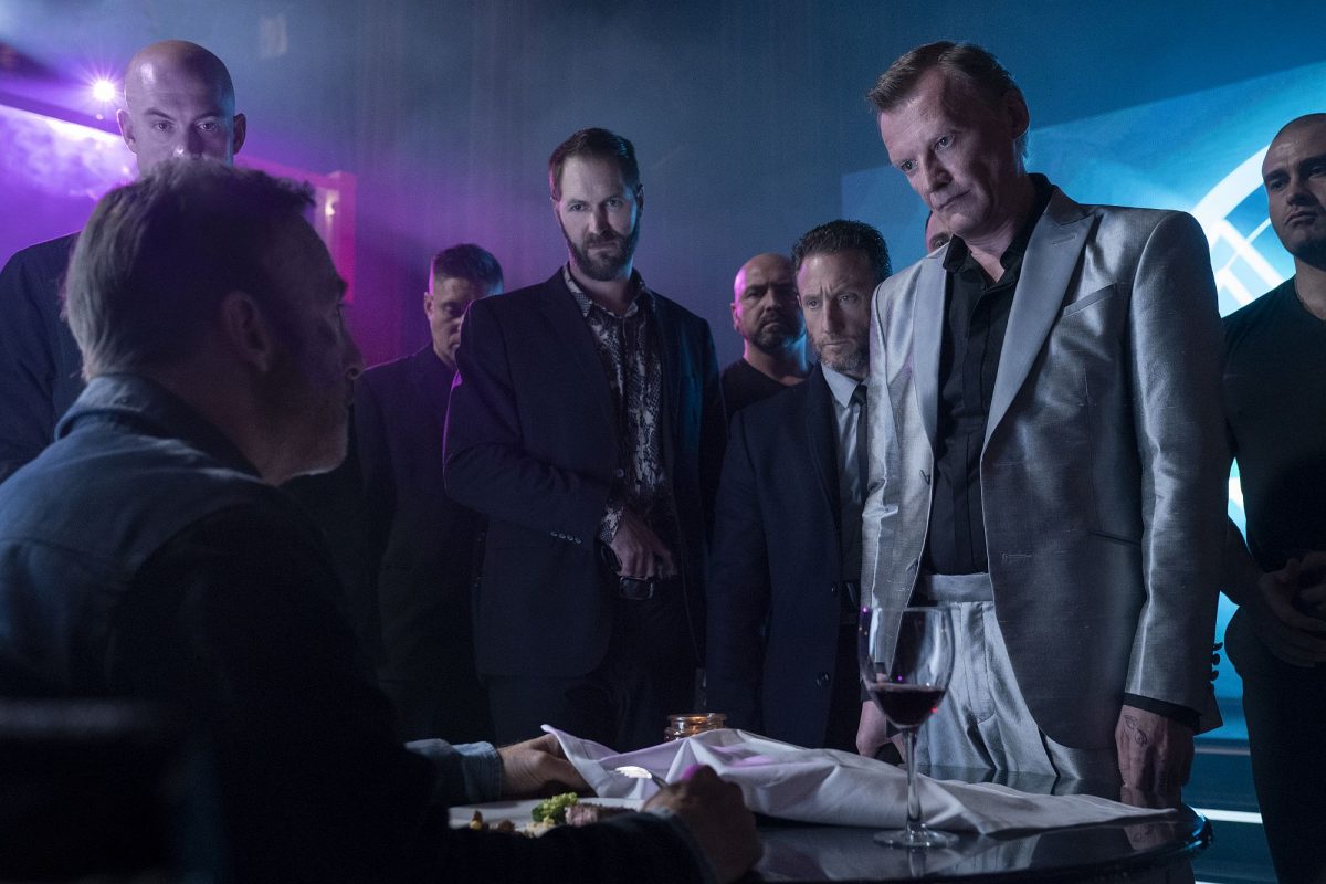 Hutch Mansell (Bob Odenkirk, sitzend mit dem Rücken zur Kamera), Albert (Neil Davison, vierter von links), Yulian Kuznetsov (Alexey Serebryakov, direkt von Odenkirk stehend) mit weiteren Mitgliedern der russischen Mafia in Nobody,