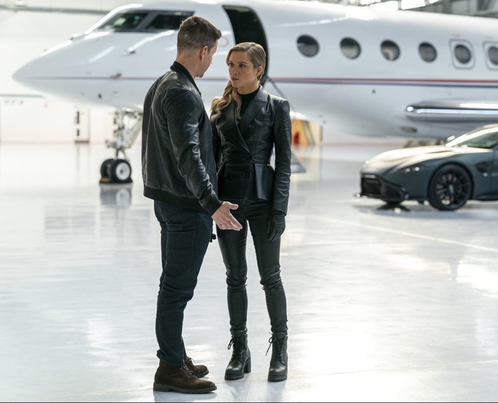Mark Wahlberg im Gespräch mit einer Frau in einem Hangar. Film Infinite auf Amazon Prime Video