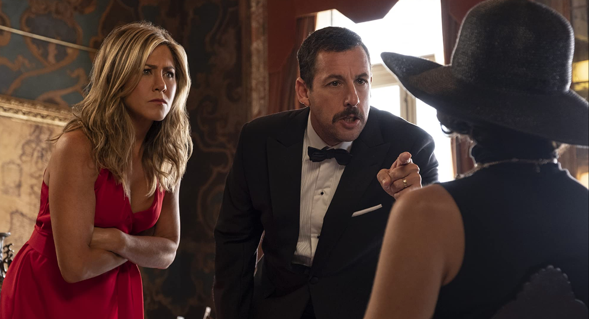 (L_R) Jennifer Aniston im roten Kleid und Adam Sandler im Smoking verhören eine Verdächtige in Murder Mystery 2